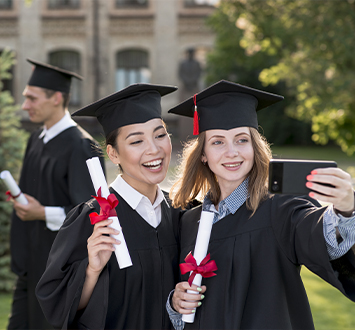 graduation concept with girls taking selfie