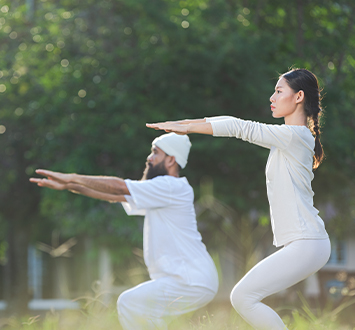 two people white outfit doing yoga nature